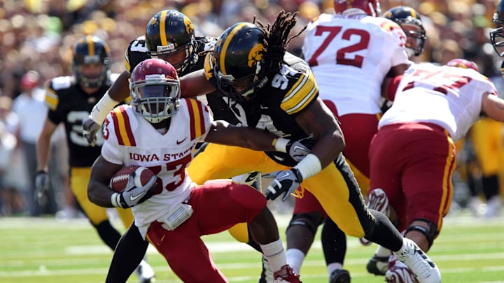 September 11, 2010; Iowa City, IA, USA; Iowa Hawkeyes Adrian Clayborn (94) tackles Iowa State Cyclones running back Leonard Johnson (23) during the first quarter at Kinnick Stadium.  Mandatory Credit: Reese Strickland-Imagn Images