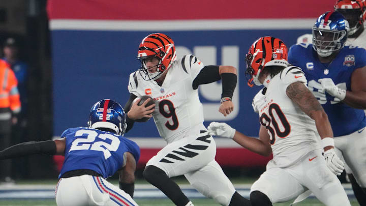 Oct 13, 2024; East Rutherford, New Jersey, USA;  Cincinnati Bengals quarterback Joe Burrow (9) runs the ball against the New York Giants during the first quarter at MetLife Stadium. Mandatory Credit: Robert Deutsch-Imagn Images