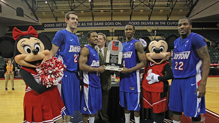 November 27, 2011; Buena Vista, FL, USA; Dayton Flyers forward Luke Fabrizius (23), guard Josh Parker (12), forward Chris Johnson (4) and guard Paul Williams (22) pose with Mickey and Minnie Mouse after they beat Minnesota Golden Gophers during the championship game of the Old Spice Classic at the HP Field House. Dayton Flyers defeated the Minnesota Golden Gophers 85-70. Mandatory Credit: Kim Klement-Imagn Images