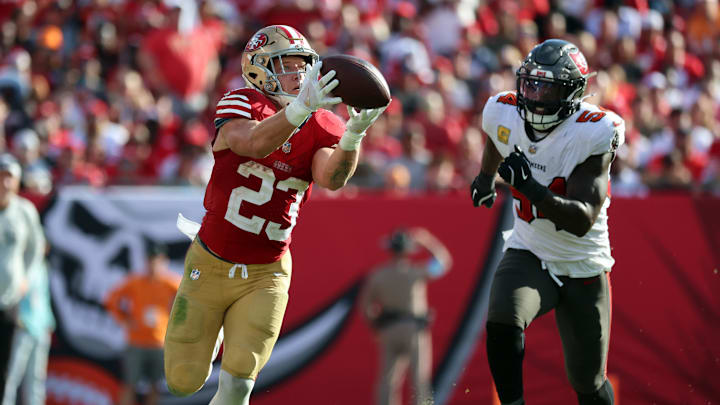 Nov 10, 2024; Tampa, Florida, USA; San Francisco 49ers running back Christian McCaffrey (23) catches the ball over Tampa Bay Buccaneers linebacker Lavonte David (54) during the second half at Raymond James Stadium. Mandatory Credit: Kim Klement Neitzel-Imagn Images