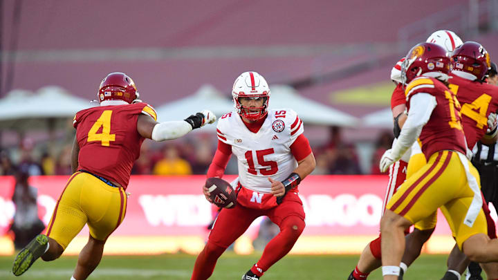 Nov 16, 2024; Los Angeles, California, USA; Nebraska Cornhuskers quarterback Dylan Raiola (15) drops back to pass as Southern California Trojans linebacker Easton Mascarenas-Arnold (4) moves in during the second half at the Los Angeles Memorial Coliseum. Mandatory Credit: Gary A. Vasquez-Imagn Images