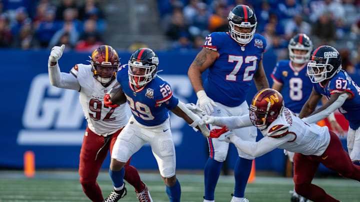 New York Giants running back Tyrone Tracy Jr. (29) breaks a tackle from Washington Commanders cornerback Noah Igbinoghene (1) during a game between the New York Giants and the Washington Commanders at MetLife Stadium in East Rutherford on Sunday, Nov. 3, 2024.