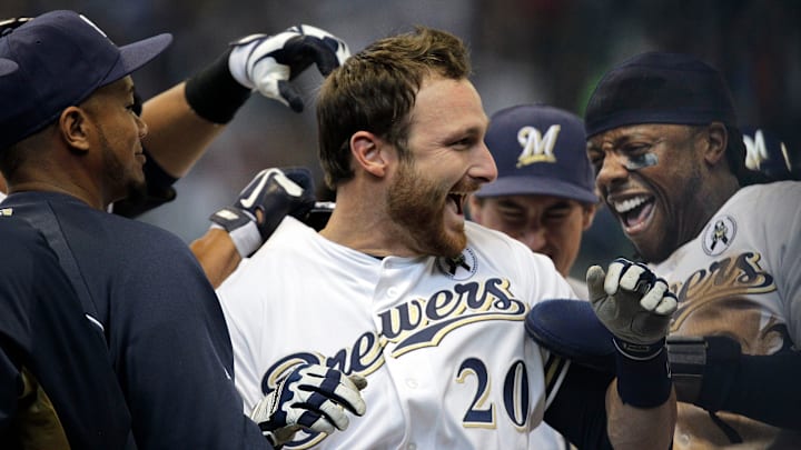Milwaukee Brewers Jonathan Lucroy is swarmed by  teammates after hitting the game-winning run during the tenth inning against the Colorado Rockies  in the regular season opener Monday, April 1, 2013 at Miller Park in Milwaukee, Wis.