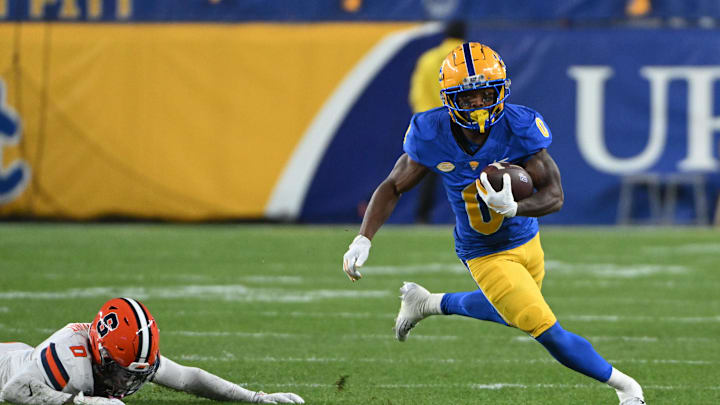Oct 24, 2024; Pittsburgh, Pennsylvania, USA; Pittsburgh Panthers running back Desmond Reid (0) eludes Syracuse Orange defensive back Duce Chestnut (0) during the first quarter  at Acrisure Stadium. Mandatory Credit: Barry Reeger-Imagn Images