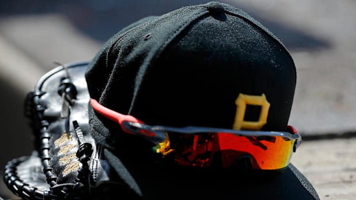 A detailed view of a Pittsburgh Pirates glove, hat and sunglasses during the eighth inning of their game against the Chicago Cubs at Wrigley Field. 