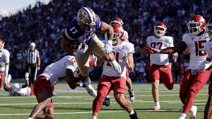 Sep 6, 2026; Seattle, Washington, USA; Washington Huskies running back Jayden Limar (17) leaps into the end zone for a touchdown as Washington State Cougars cornerback Khamari Terrell (13) defends during the fourth quarter at Husky Stadium. Sep 6, 2026; Seattle, Washington, USA; Washington Huskies running back Jayden Limar (17) leaps into the end zone for a touchdown as Washington State Cougars cornerback Khamari Terrell (13) defends during the fourth quarter at Husky Stadium.