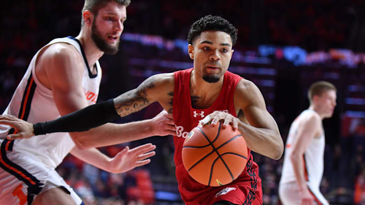 Feb 10, 2026; Champaign, Illinois, USA;  Wisconsin Badgers guard Nick Boyd (2) drives the ball past Illinois Fighting Illini center Tomislav Ivisic (13) during the second half at State Farm Center. 