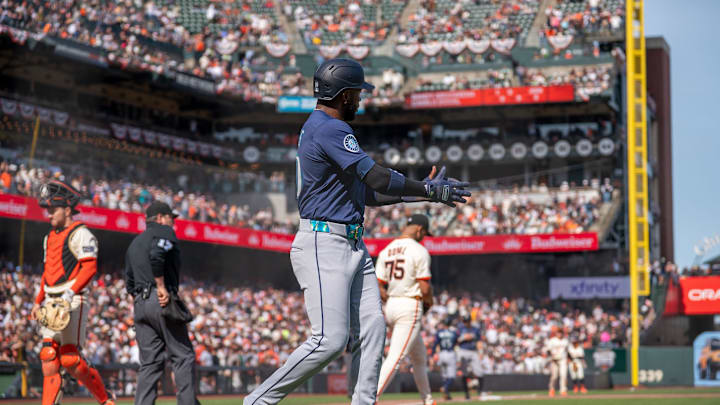 Seattle Mariners right fielder Victor Robles (10) claps and celebrates with Seattle Mariners left fielder Randy Arozarena (not pictured) for driving in the run during the ninth inning against the San Francisco Giants at Oracle Park on April 6.