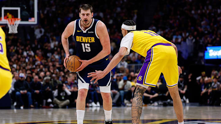 Mar 5, 2026; Denver, Colorado, USA; Denver Nuggets center Nikola Jokic (15) controls the ball as Los Angeles Lakers center Jaxson Hayes (11) guards in the first quarter at Ball Arena. Mandatory Credit: Isaiah J. Downing-Imagn Images
