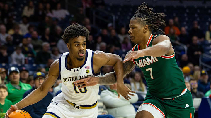 Jan 13, 2026; South Bend, Indiana, USA; Notre Dame Fighting Irish forward Jalen Haralson (10) drives against Miami (FL) Hurricanes forward Shelton Henderson (7) during the first half at Purcell Pavilion at the Joyce Center. Mandatory Credit: Michael Caterina-Imagn Images