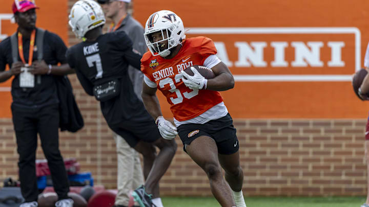 Jan 30, 2025; Mobile, AL, USA; National team running back Bhayshul Tuten of Virginia Tech (33) works through drills during Senior Bowl practice for the National team at Hancock Whitney Stadium. Mandatory Credit: Vasha Hunt-Imagn Images