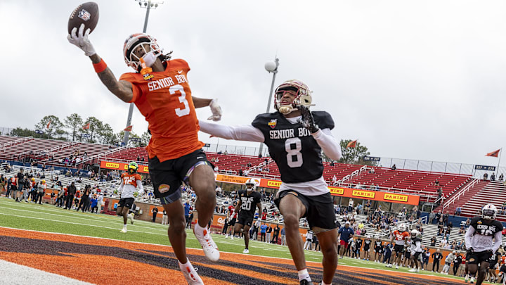 Jan 30, 2025; Mobile, AL, USA; National team wide receiver Pat Bryant II of Illinois (3) tries for a one hand catch as National team defensive back Azareye'h Thomas of Florida State (8) defends during Senior Bowl practice for the National team at Hancock Whitney Stadium. Mandatory Credit: Vasha Hunt-Imagn Images