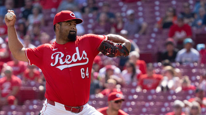 Cincinnati Reds pitcher Tony Santillan (64) delivers a pitch