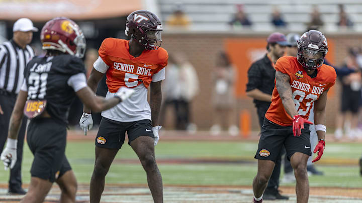 Jan 30, 2025; Mobile, AL, USA; National team wide receiver Da'Quan Felton of Virginia Tech (5) and National team wide receiver Jaylin Lane of Virginia Tech (83) talk before a play during Senior Bowl practice for the National team at Hancock Whitney Stadium. Mandatory Credit: Vasha Hunt-Imagn Images