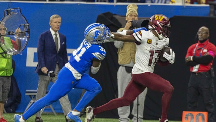 Jan 18, 2025; Detroit, Michigan, USA; Washington Commanders wide receiver Terry McLaurin (17) runs the ball against Detroit Lions safety Kerby Joseph (31)  during the second quarter at Ford Field. Mandatory Credit: David Reginek-Imagn Images