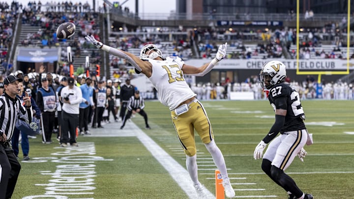 Dec 27, 2024; Birmingham, AL, USA;  Georgia Tech Yellow Jackets wide receiver Isiah Canion (13) misses a pass in the end zone with Vanderbilt Commodores defensive back Jaylin Lackey (27) trailing the play during the first half of the 2024 Birmingham Bowl at Protective Stadium. Mandatory Credit: Vasha Hunt-Imagn Images
