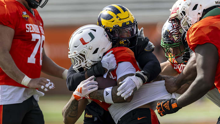 Jan 28, 2025; Mobile, AL, USA; National team defensive lineman Josaiah Stewart of Michigan stops National team running back Damien Martinez of Miami during Senior Bowl practice for the National team at Hancock Whitney Stadium. 