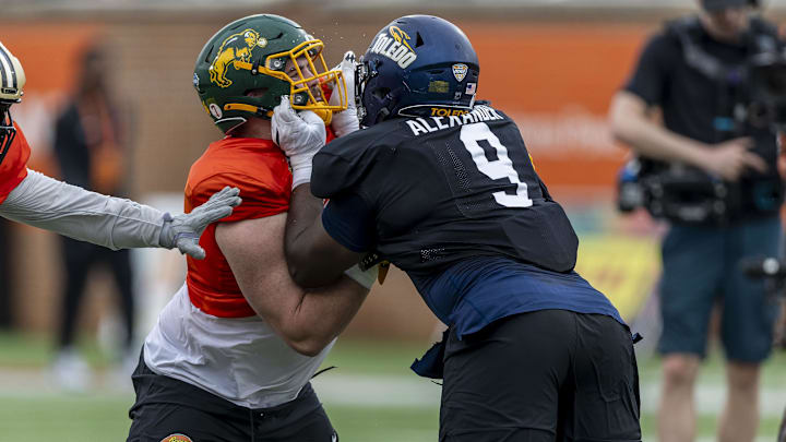 Offensive lineman Grey Zabel of North Dakota State works against National DL Darius Alexander of Toledo during Senior Bowl practice.
