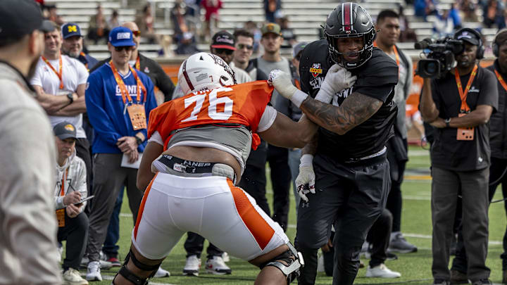 Jan 28, 2025; Mobile, AL, USA; American team offensive lineman Carson Vinson of Alabama A&M (76) spars with American team defensive lineman Kyle Kennard of South Carolina (9) during Senior Bowl practice for the American team at Hancock Whitney Stadium. Mandatory Credit: Vasha Hunt-Imagn Images