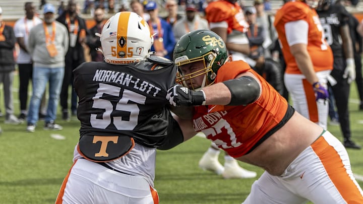 Jan 28, 2025; Mobile, AL, USA; American team defensive lineman Omarr Norman-Lott of Tennessee (55) spars with American team offensive lineman Jackson Slater of Sacramento State (67) during Senior Bowl practice for the American team at Hancock Whitney Stadium. 