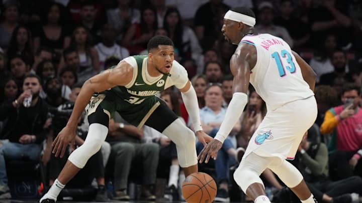 Apr 5, 2025; Miami, Florida, USA;  Miami Heat center Bam Adebayo (13) looks to pass the ball as Milwaukee Bucks forward Giannis Antetokounmpo (34) defends during the second half at Kaseya Center. Mandatory Credit: Jim Rassol-Imagn Images