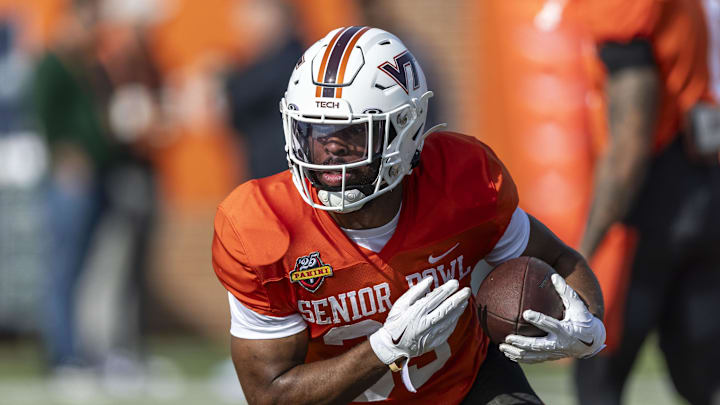 Jan 29, 2025; Mobile, AL, USA; National team running back Bhayshul Tuten of Virginia Tech (33) runs the ball during Senior Bowl practice for the National team at Hancock Whitney Stadium. Mandatory Credit: Vasha Hunt-Imagn Images