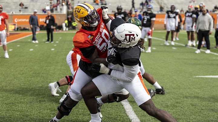 Jan 28, 2025; Mobile, AL, USA; American team offensive lineman Emery Jones of LSU (50) spars with American team defensive lineman Shemar Stewart of Texas A&M (14) during Senior Bowl practice for the American team at Hancock Whitney Stadium. Mandatory Credit: Vasha Hunt-Imagn Images