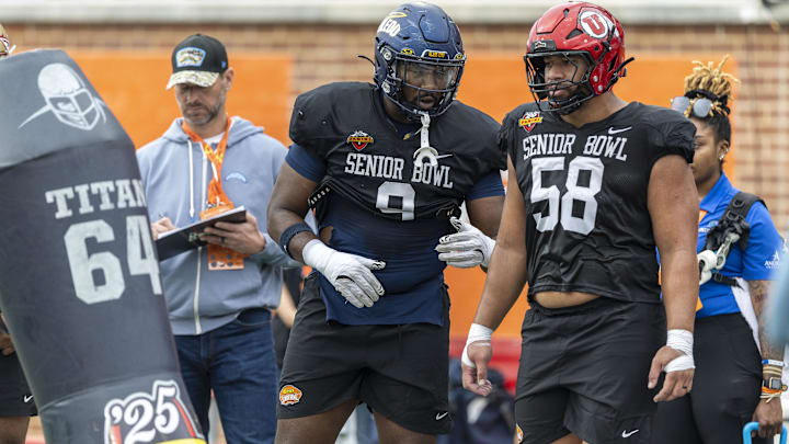 Jan 30, 2025; Mobile, AL, USA; National team defensive lineman Darius Alexander of Toledo (9) and National team defensive lineman Junior Tafuna of Utah (58) talks as they go through drills during Senior Bowl practice for the National team at Hancock Whitney Stadium. Mandatory Credit: Vasha Hunt-Imagn Images