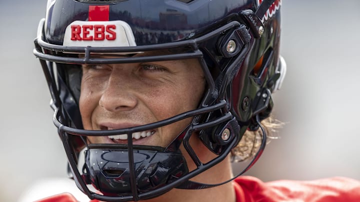 Jan 28, 2025; Mobile, AL, USA; American team quarterback Jaxson Dart of Ole Miss (2) interacts with teammates during Senior Bowl practice for the American team at Hancock Whitney Stadium. Mandatory Credit: Vasha Hunt-Imagn Images