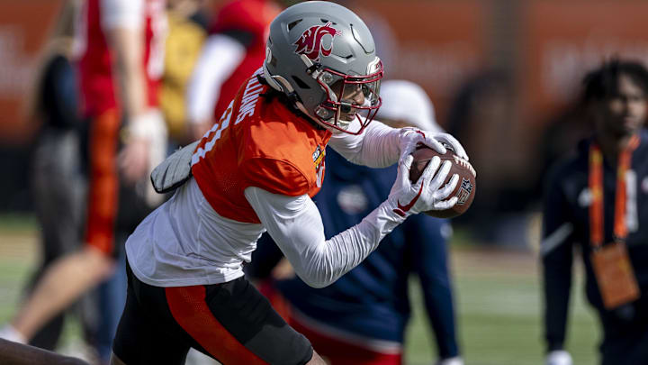 Jan 28, 2025; Mobile, AL, USA; National team wide receiver Kyle Williams of Washington State (11) grabs a pass during Senior Bowl practice for the National team at Hancock Whitney Stadium. Mandatory Credit: Vasha Hunt-Imagn Images