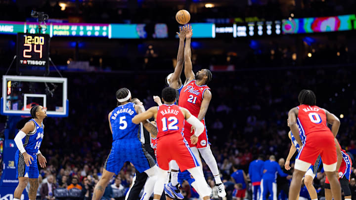 Apr 12, 2024; Philadelphia, Pennsylvania, USA; Philadelphia 76ers center Joel Embiid (21) and Orlando Magic center Wendell Carter Jr. (34) tip off to start the first quarter at Wells Fargo Center. Mandatory Credit: Bill Streicher-Imagn Images