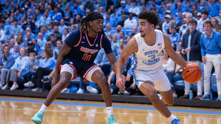 Nov 11, 2025; Chapel Hill, North Carolina, USA; Radford Highlanders guard Jr. Dennis Parker (11) presses North Carolina Tar Heels guard Derek Dixon (3) in the first half at Dean E. Smith Center. 