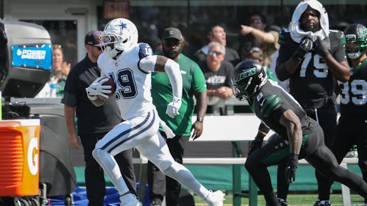 Dallas Cowboys wide receiver Ryan Flournoy runs with the ball as New York Jets safety Andre Cisco.