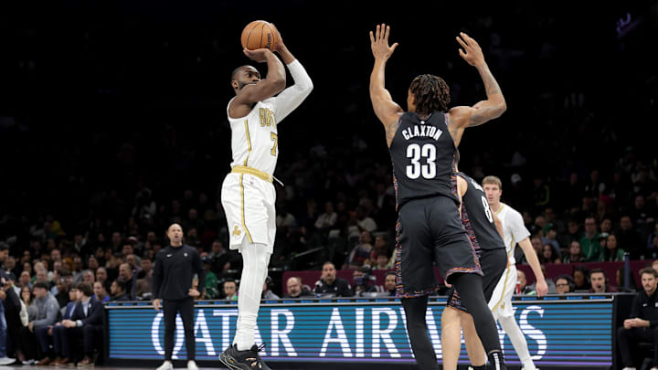Jan 23, 2026; Brooklyn, New York, USA; Boston Celtics guard Jaylen Brown (7) takes a shot against Brooklyn Nets center Nic Claxton (33) and guard Egor Demin (8) during the first quarter at Barclays Center. Mandatory Credit: Brad Penner-Imagn Images