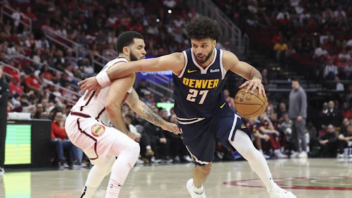 Mar 23, 2025; Houston, Texas, USA; Denver Nuggets guard Jamal Murray (27) drives with the ball as Houston Rockets guard Fred VanVleet (5) defends during the fourth quarter at Toyota Center. Mandatory Credit: Troy Taormina-Imagn Images