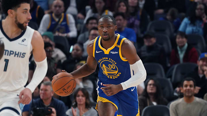 Jan 4, 2025; San Francisco, California, USA;  Golden State Warriors forward Jonathan Kuminga (00) dribbles up court in front of Memphis Grizzlies guard Scotty Pippen Jr. (1) in the second quarter at Chase Center. Mandatory Credit: David Gonzales-Imagn Images