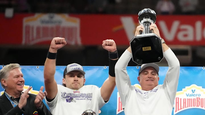 Dec 30, 2025; San Antonio, TX, USA; TCU Horned Frogs quarterback Ken Seals (center) and head coach Sonny Dykes celebrate after victory over Southern California Trojans in the Alamo Bowl as Valero chief operating officer Gary Simmons (left) watches at Alamodome. Mandatory Credit: Kirby Lee-Imagn Images