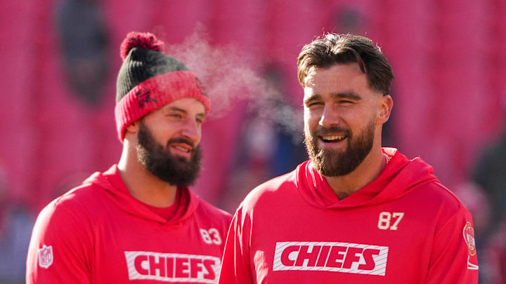 Dec 21, 2024; Kansas City, Missouri, USA; Kansas City Chiefs tight end Travis Kelce (87) laughs with tight end Noah Gray (83) during warm ups against the Houston Texans prior to a game at GEHA Field at Arrowhead Stadium. Mandatory Credit: Denny Medley-Imagn Images