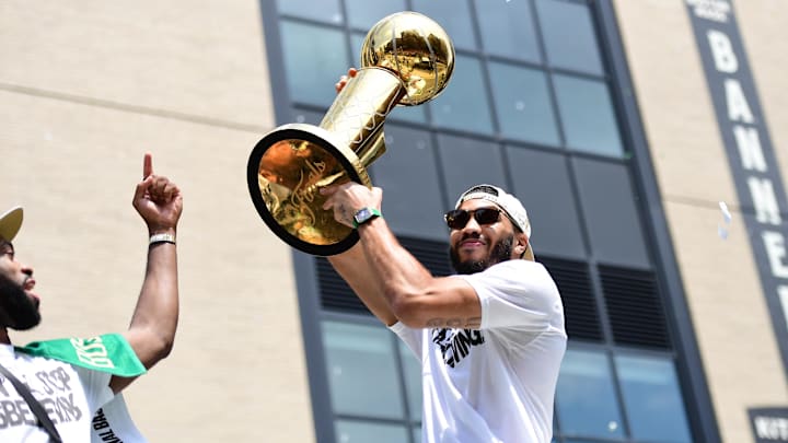 Jun 21, 2024; Boston, MA, USA;  Boston Celtics player Jayson Tatum holds the Larry OíBrien trophy during the Boston Celtics Championship parade. Mandatory Credit: Bob DeChiara-USA TODAY Sports