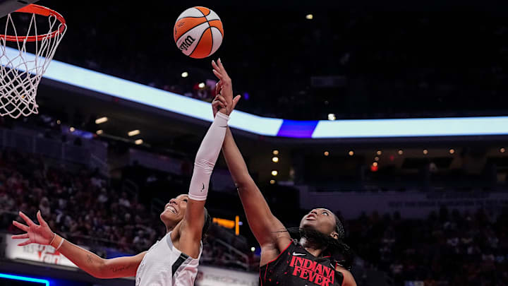 Indiana Fever forward Aliyah Boston (7) reaches for the ball against Las Vegas Aces center A'ja Wilson (22) on Thursday, July 24, 2025, during the game at Gainbridge Fieldhouse in Indianapolis.