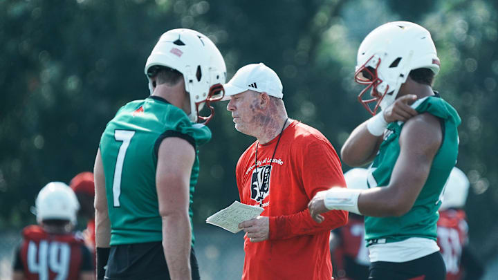 Louisville Cardinals head football coach Jeff Brohm with quarterbacks Miller Moss (7) and Deuce Adams (13) at a morning practice Wednesday, July 30, 2025. The Cardinals' 2024 record: 9–4, 5–3 in the ACC. Louisville Cardinals head football coach Jeff Brohm with quarterbacks Miller Moss (7) and Deuce Adams (13) at a morning practice Wednesday, July 30, 2025. The Cardinals' 2024 record: 9–4, 5–3 in the ACC.