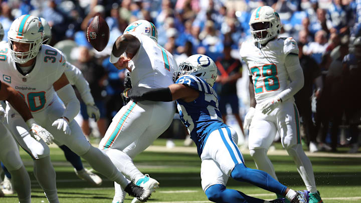 Indianapolis Colts cornerback Kenny Moore II (23) causes a fumble by Miami Dolphins quarterback Tua Tagovailoa (1) during the first half at Lucas Oil Stadium.