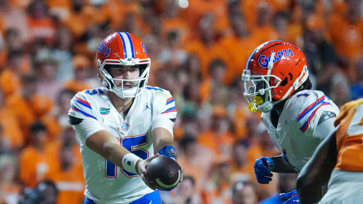 Florida Gators quarterback Graham Mertz (15) hands the ball to running back Montrell Johnson Jr. (1) against the Tennessee Volunteers Florida Gators quarterback Graham Mertz (15) hands the ball to running back Montrell Johnson Jr. (1) against the Tennessee Volunteers