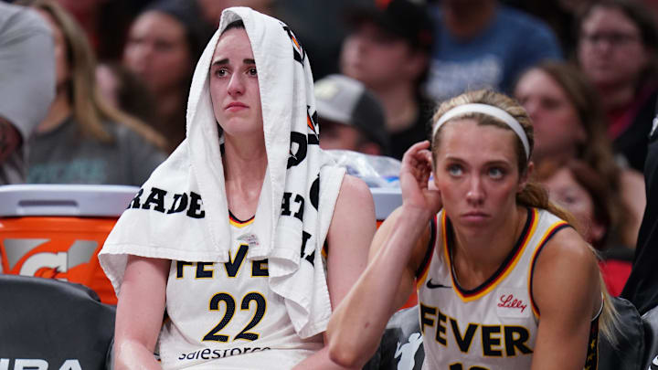Caitlin Clark (left) reacts on the bench during the Fever's game against the Sun Tuesday, which she left due to injury.