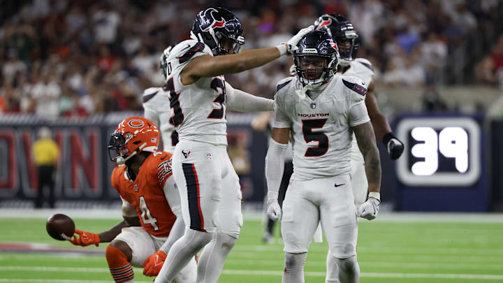 Sep 15, 2024; Houston, Texas, USA; Houston Texans safety Jalen Pitre (5) celebrates his tackle against Chicago Bears running back D'Andre Swift (4) in the second half at NRG Stadium.