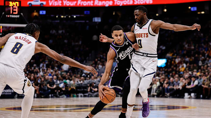 Feb 28, 2024; Denver, Colorado, USA; Sacramento Kings forward Keegan Murray (13) controls the ball against Denver Nuggets forward Justin Holiday (9) and forward Peyton Watson (8) in the fourth quarter at Ball Arena. Mandatory Credit: Isaiah J. Downing-Imagn Images