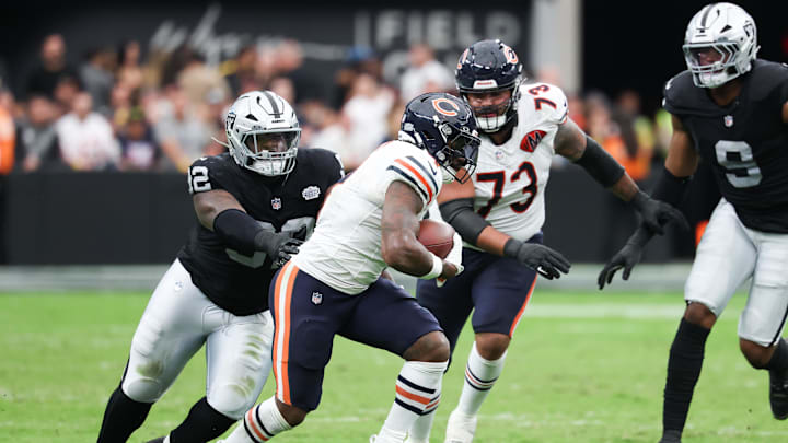 Sep 28, 2025; Paradise, Nevada, USA; Chicago Bears running back d'Andre Swift (4) is pressed by Las Vegas Raiders defensive tackle JJ Pegues (92) during the second quarter at Allegiant Stadium. Mandatory Credit: Kiyoshi Mio-Imagn Images