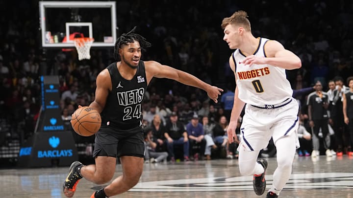 Oct 29, 2024; Brooklyn, New York, USA; Brooklyn Nets small guard Cam Thomas (24) dribbles the ball against Denver Nuggets guard Christian Braun (0) during the second half at Barclays Center. Mandatory Credit: Gregory Fisher-Imagn Images