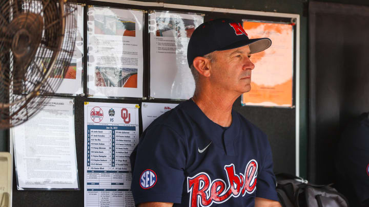 Jun 26, 2022; Omaha, NE, USA; Ole Miss Head Coach Mike Bianco sits in the dugout just before the first inning against the Oklahoma Sooners at Charles Schwab Field. Mandatory Credit: Jaylynn Nash-USA TODAY Sports