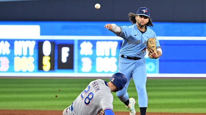 Toronto Blue Jays shortstop Bo Bichette throws to first